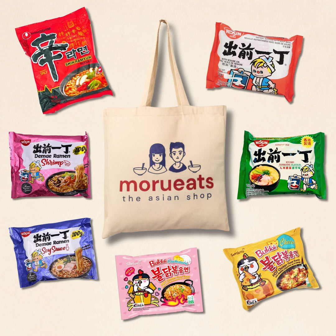 Tote bag with 'morueats' branding surrounded by selection of instant noodle packages on a beige background